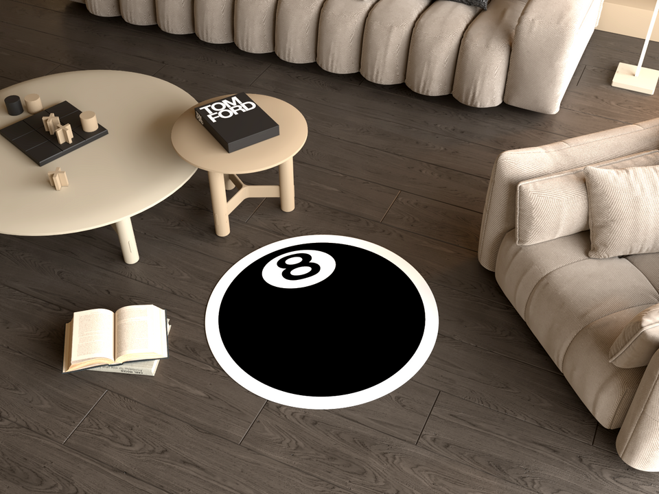 A modern living room featuring a round rug designed like an 8 ball, with a black and white color scheme. All creating a stylish and cozy atmosphere.